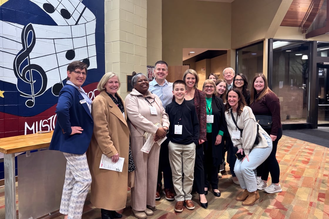 Smiling group in music-themed space